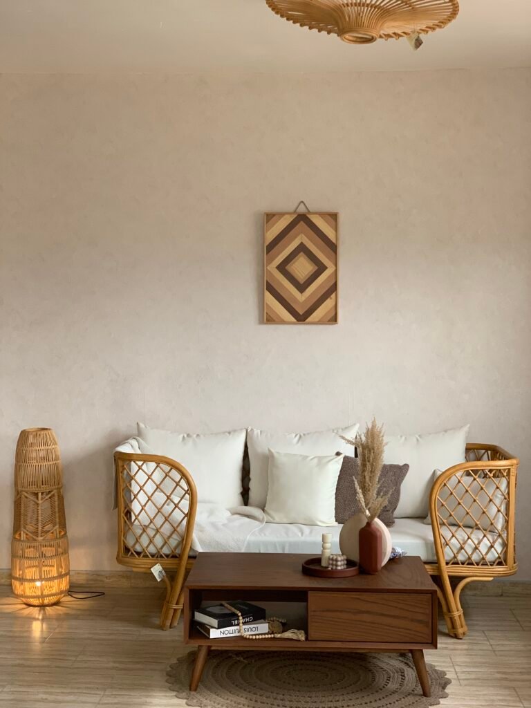 MASHRABIYA three seater rattan sofa with white cushions in a modern living room