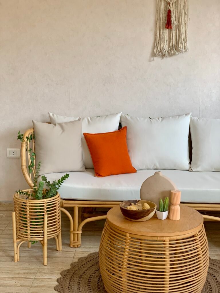 Three seater LOTUS rattan sofa against a white textured wall