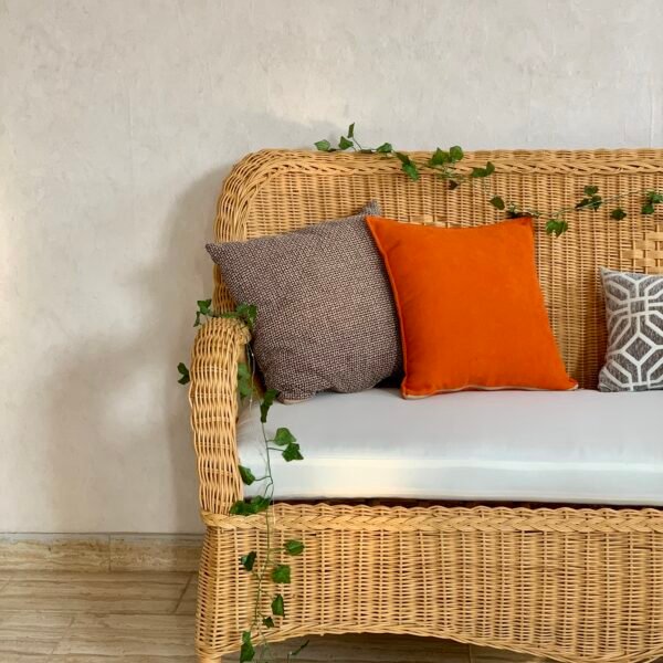 Scalloped apron and tapered legs of MARSA woven loveseat