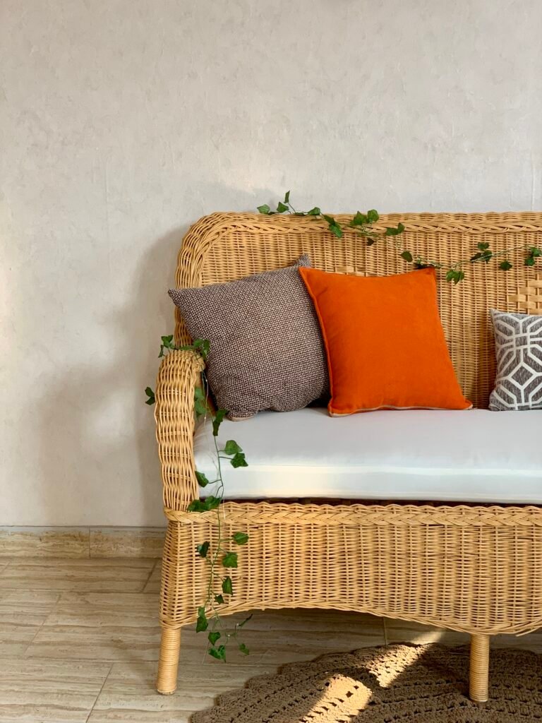 Scalloped apron and tapered legs of MARSA woven loveseat